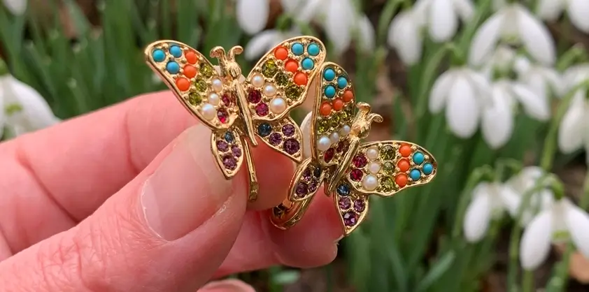 Multi colour vintage butterfly earrings with snowdrop flowers in background