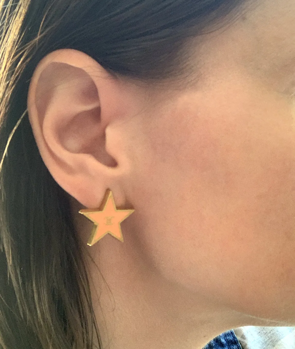 Chanel star earring on the ear