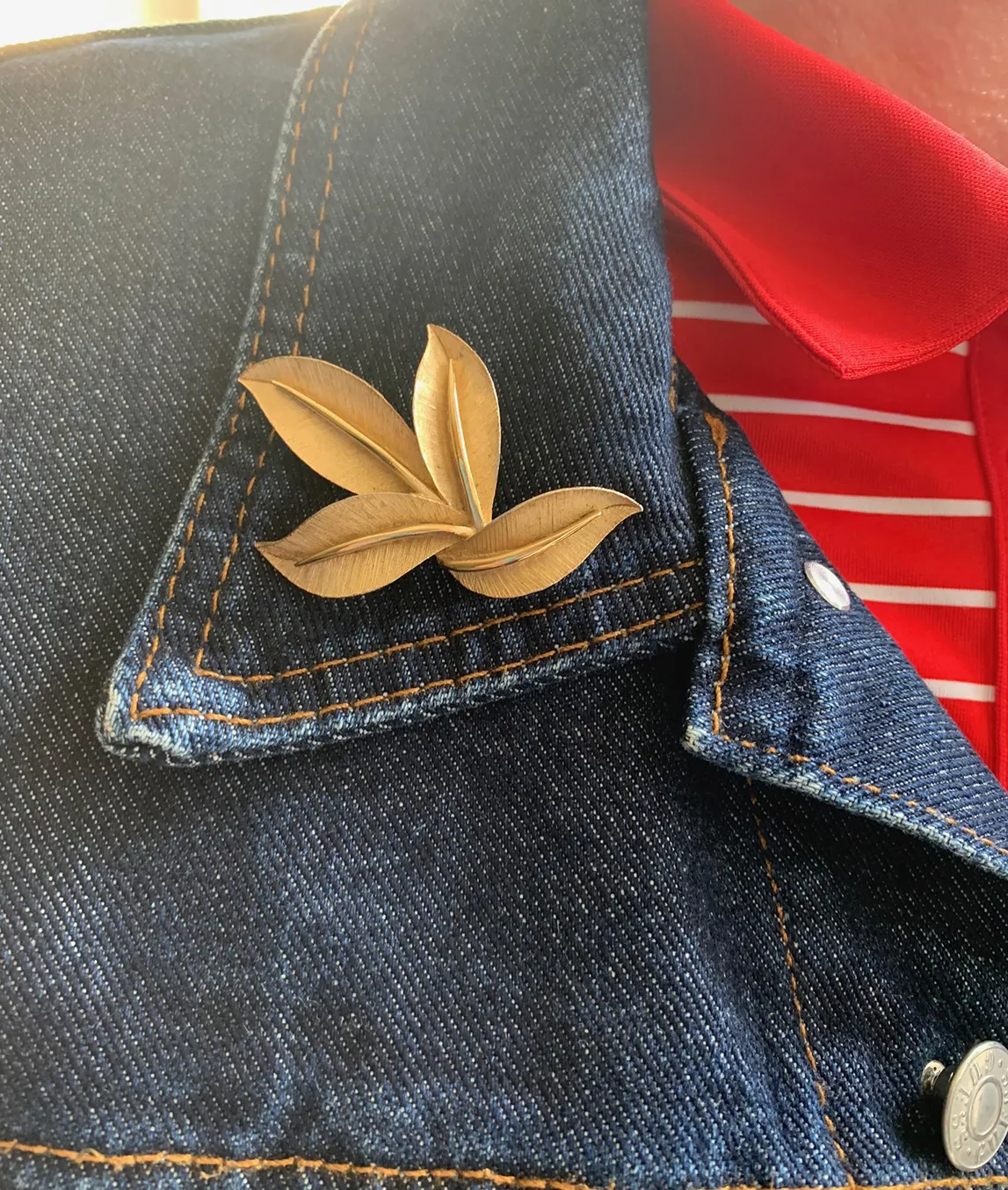 Trifari golden brooch on denim