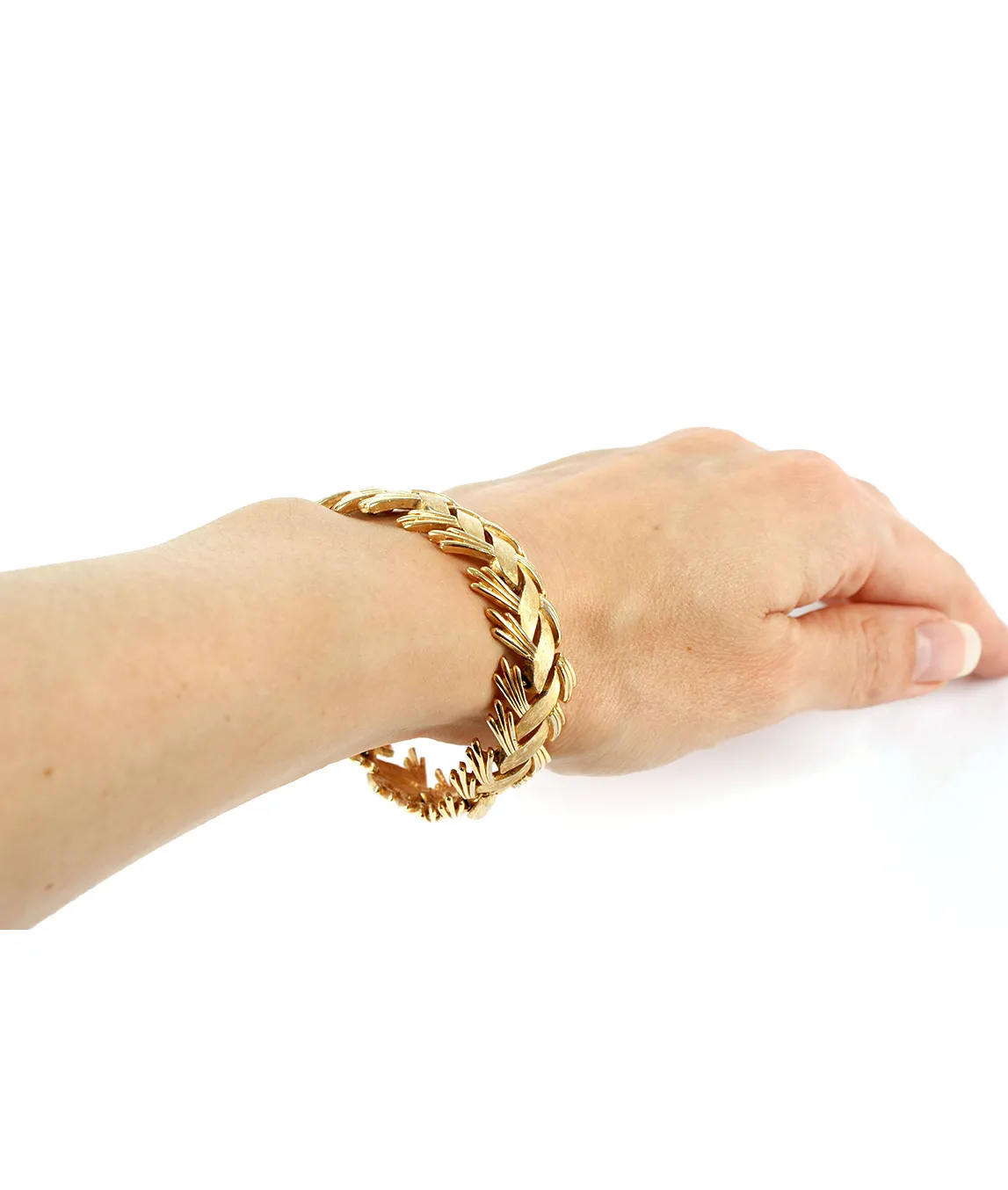 Gold Trifari bracelet on the arm