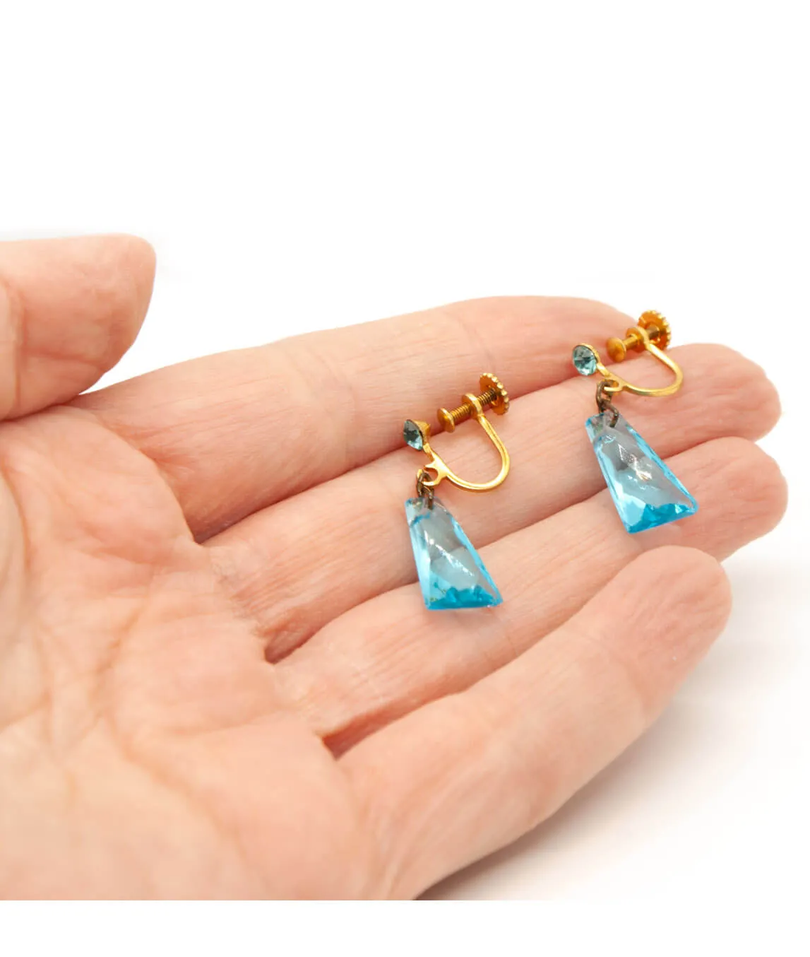 Vintage blue glass earrings in the hand