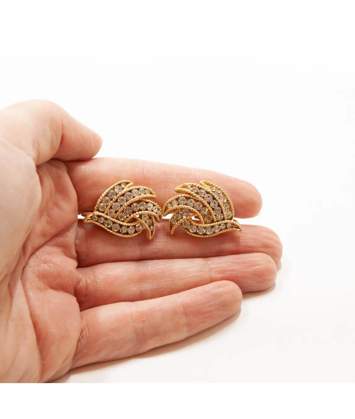 Crown Trifari earrings held in