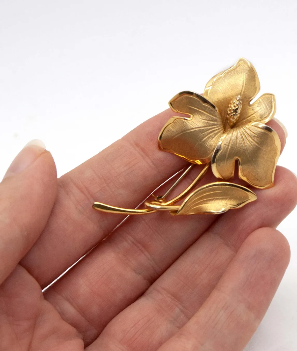 Ecco Rolled Gold Floral Brooch Pin held in hand