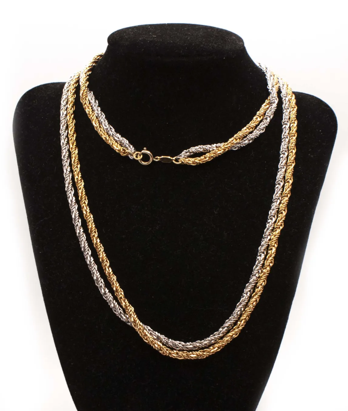 Two strand long rope chain in silver and gold Grossé sitting on black display