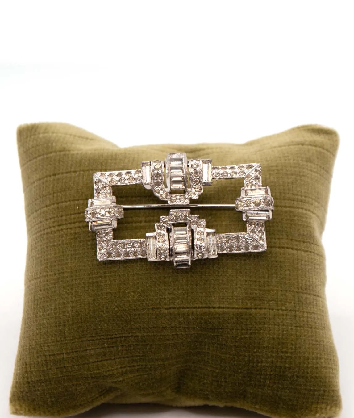 Art Deco 1930s Trifari KTF brooch on green pillow