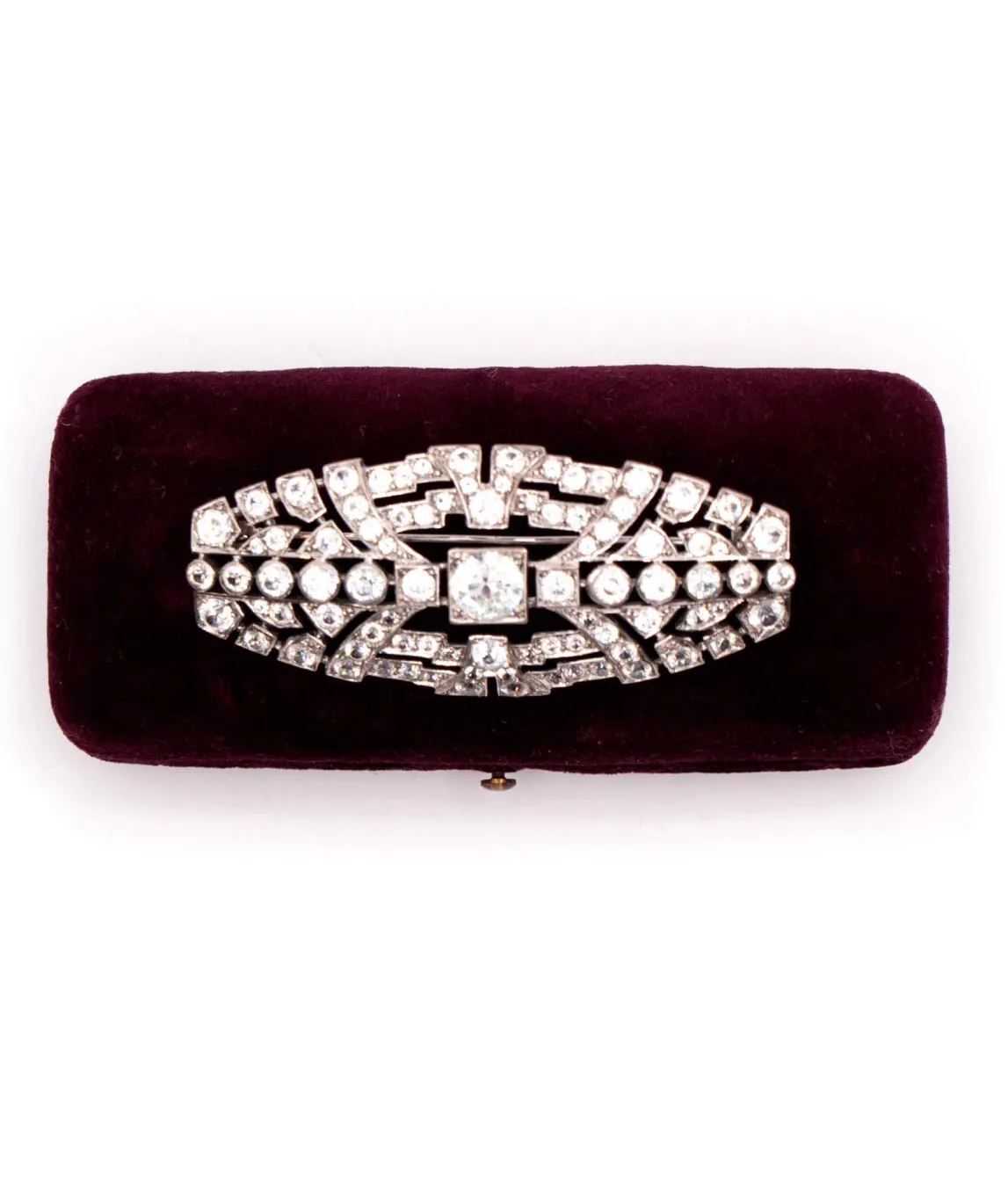 Art Deco brooch set with zircons on burgundy velvet box
