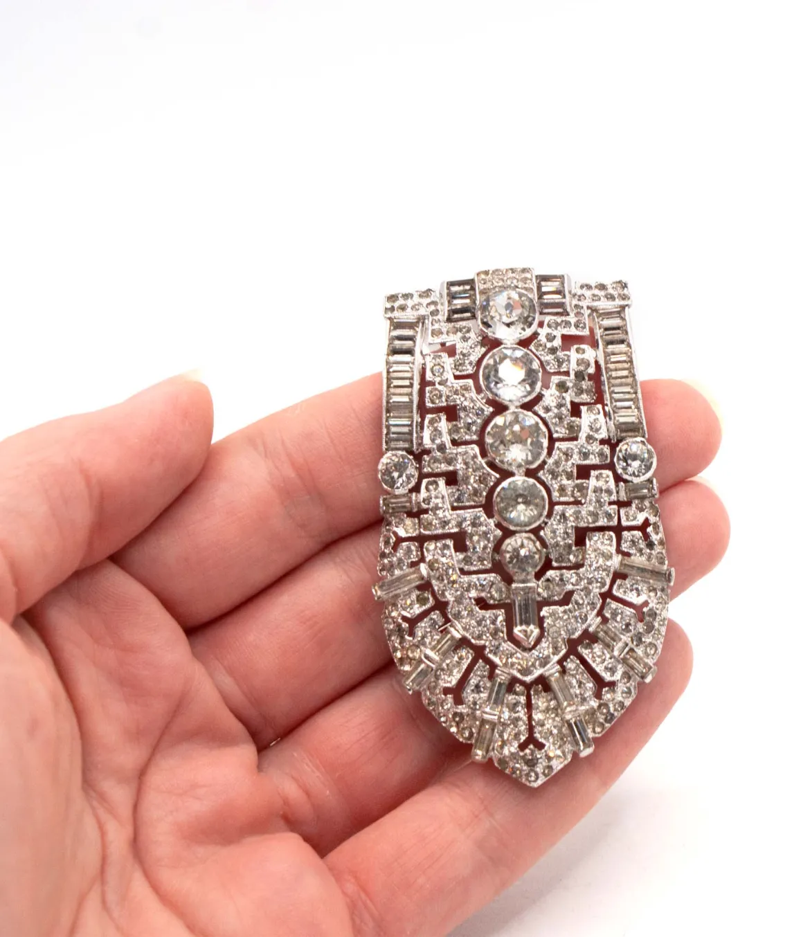 Large Trifari KTF dress clip held in a hand