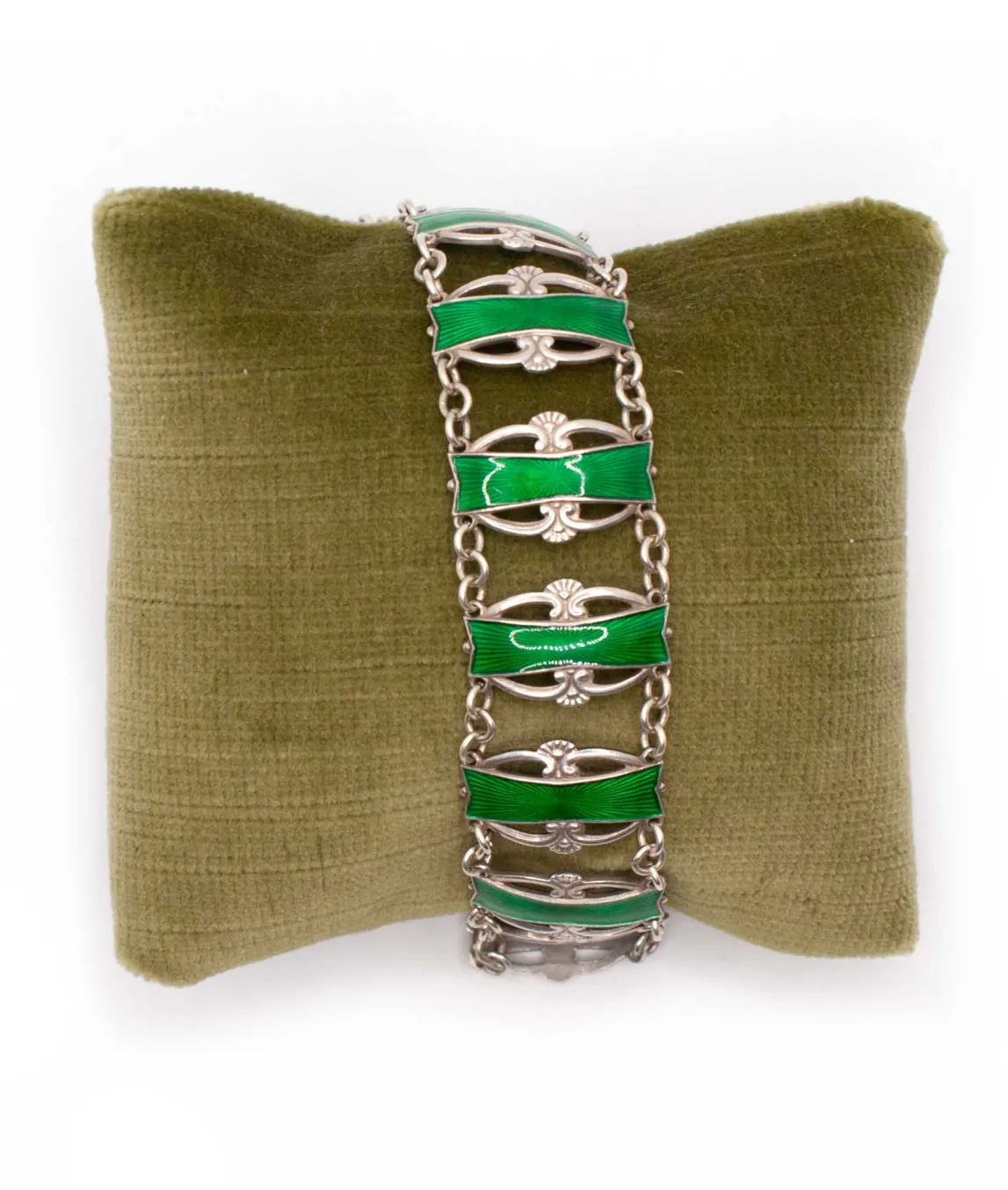 Emerald green enamel on sterling silver vintage bracelet wrapped around green pillow