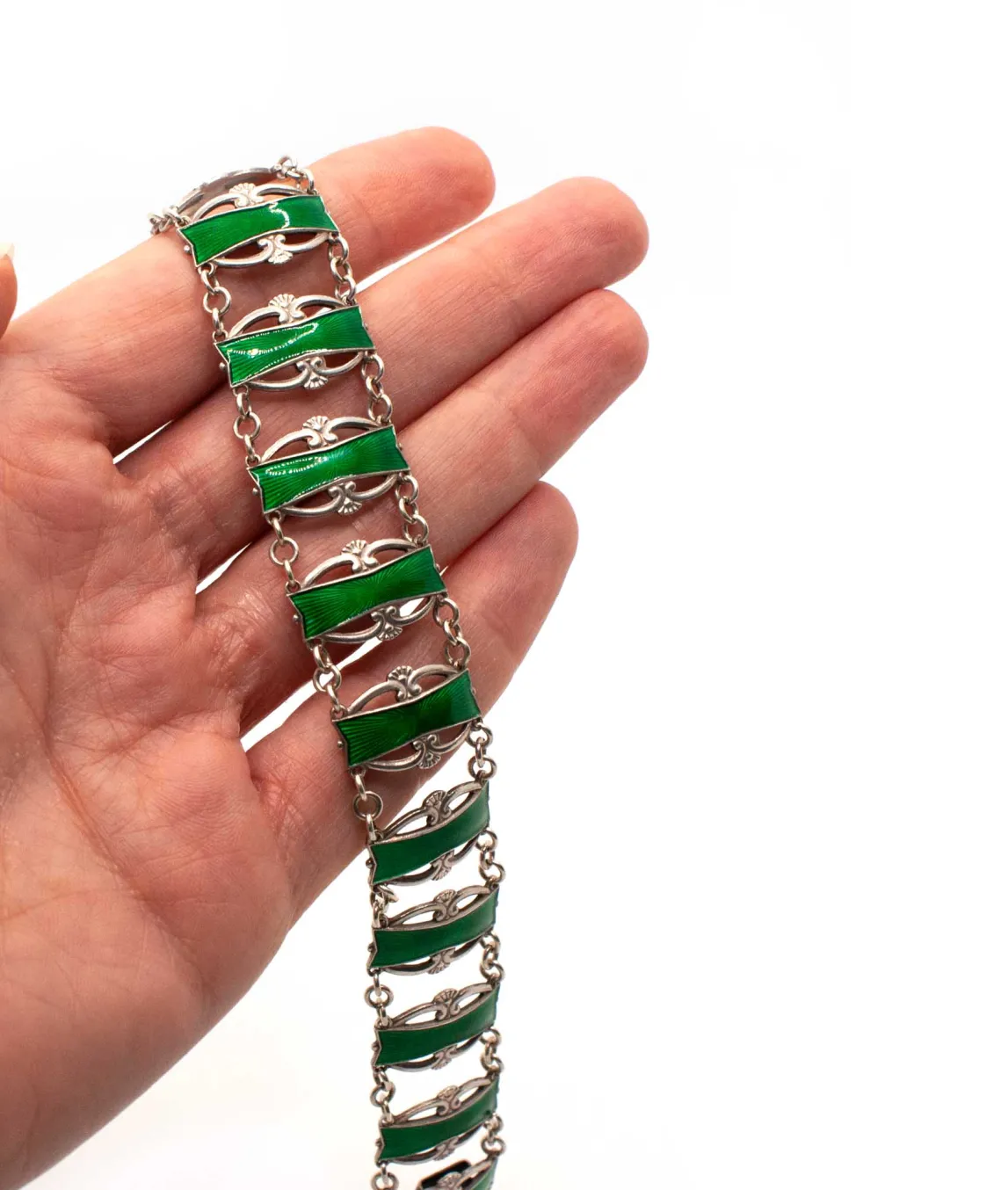Emerald green enamel on sterling silver vintage bracelet held in hand