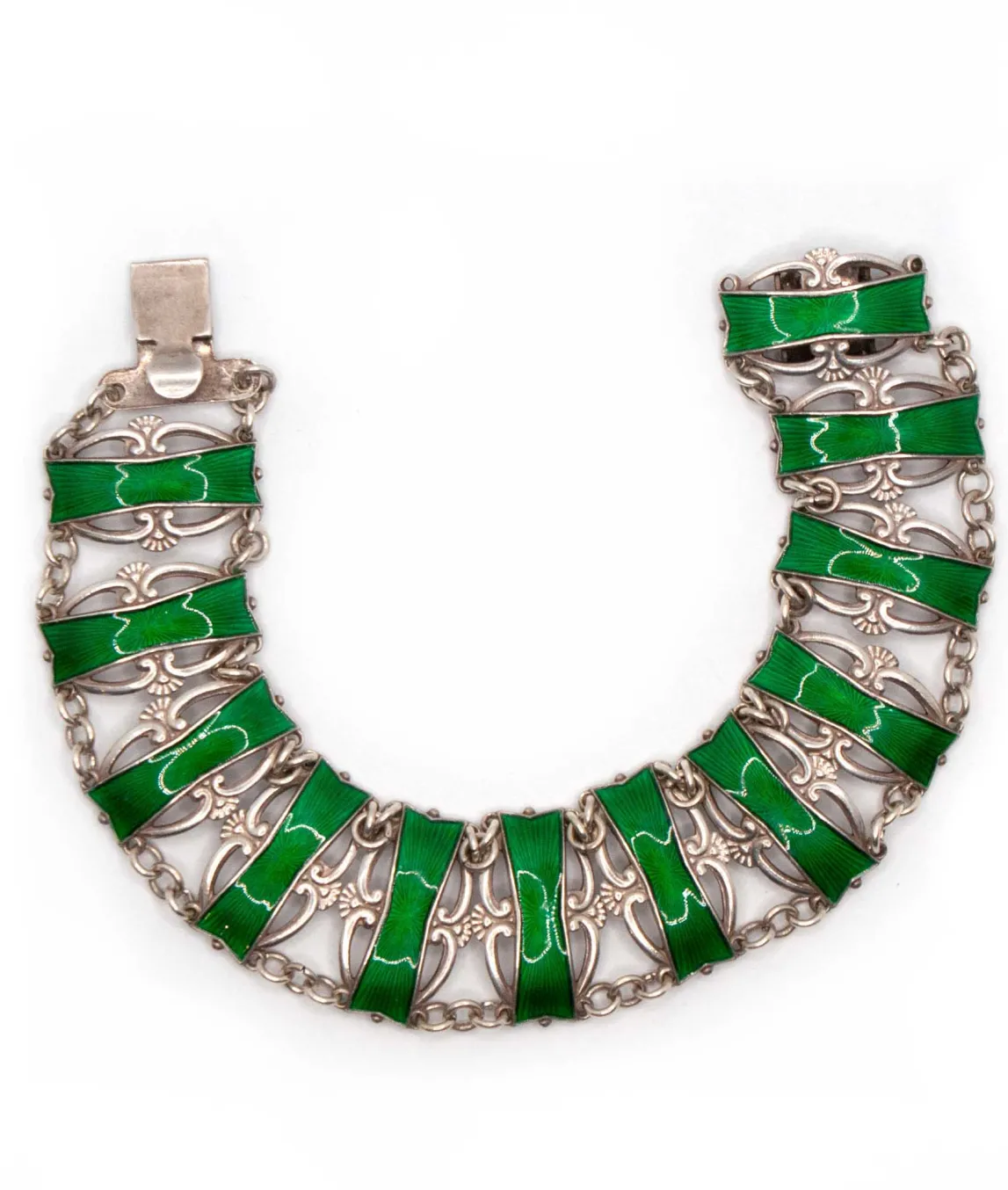 Silver and green enamel bracelet by Ivar Holth laying in a u shape
