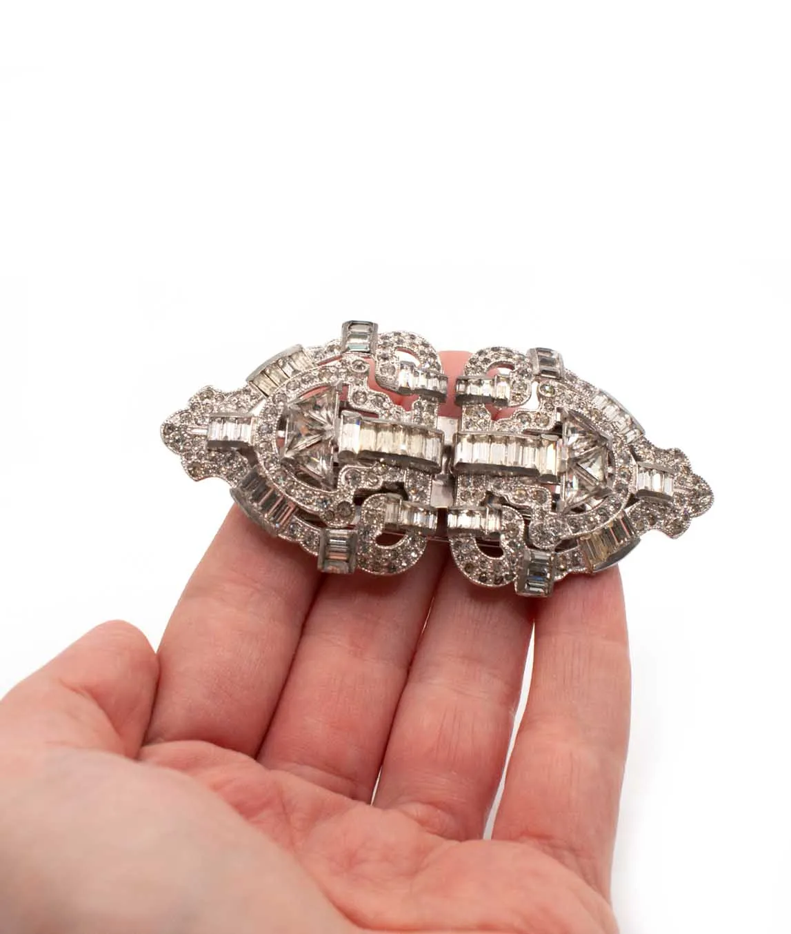 Large Art Deco double dress clip brooch held in a hand