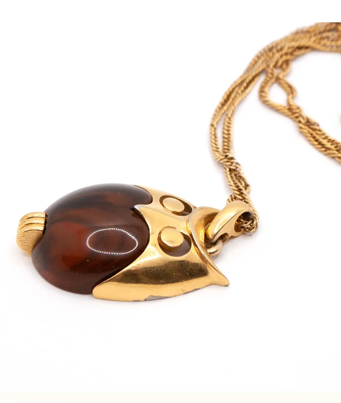 Side view of brown and gold Trifari owl pendant with slight plating chips to the bottom