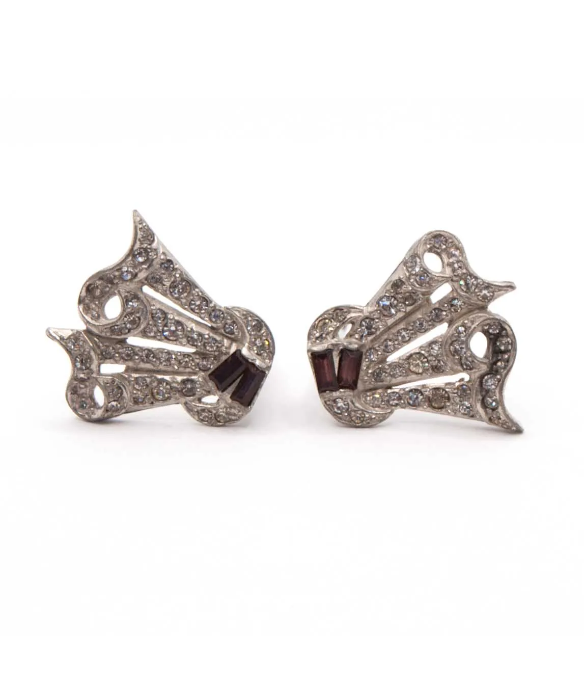 Two Art Deco dress clips on their sides decorated with clear rhinestones and purple baguettes