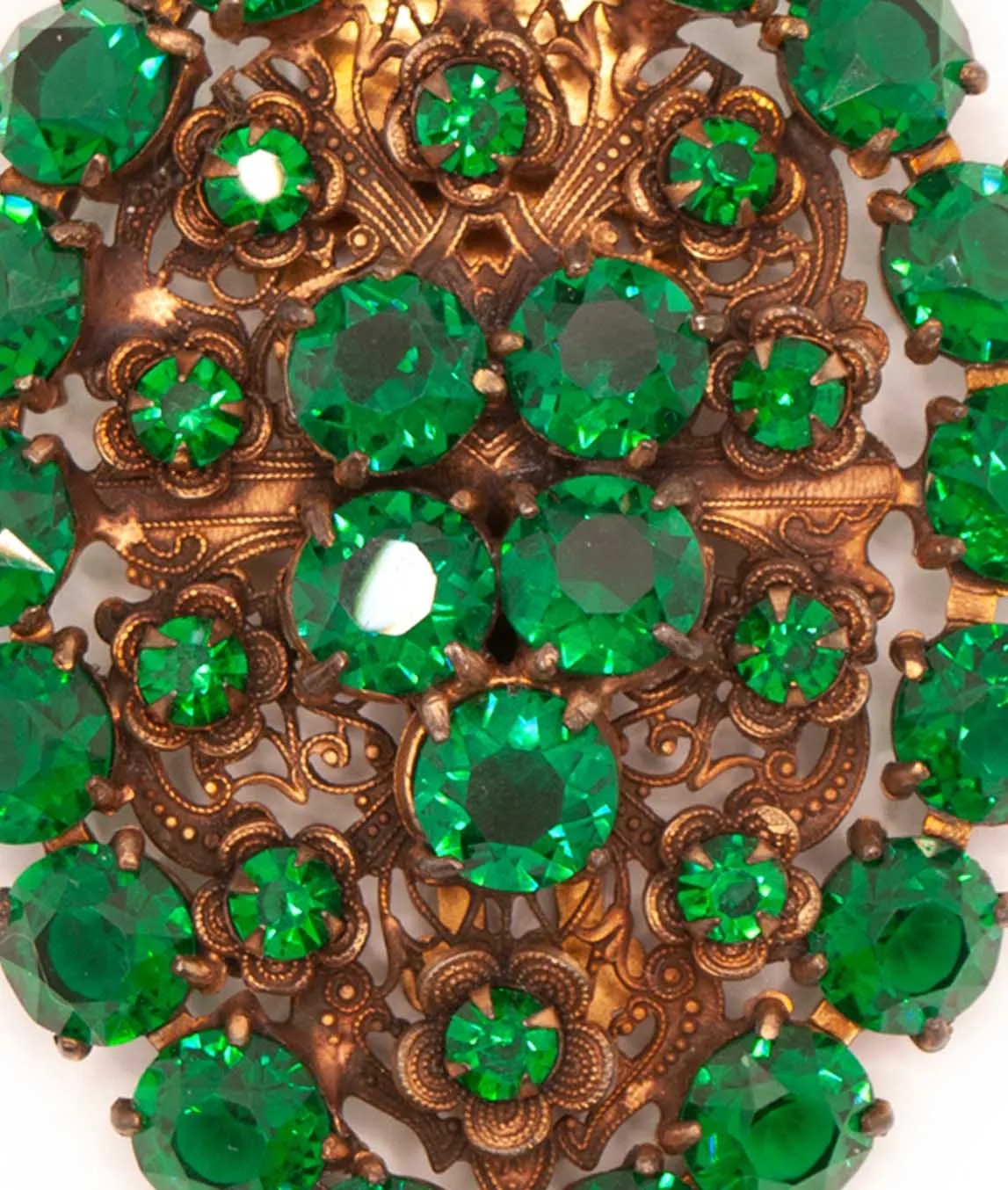 Green glass crystals set on copper coloured metal of Art Deco dress clip