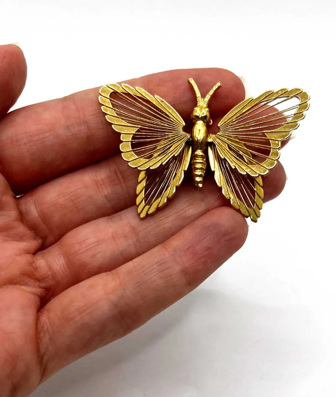 Monet gold tone wire work butterfly held in hand