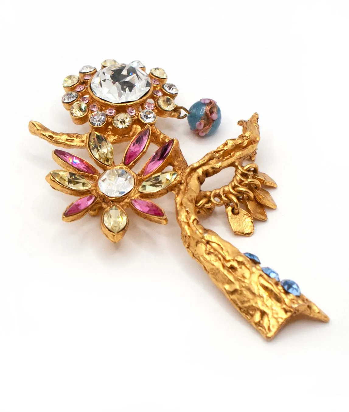 Top side view of Christian Lacroix flower pin with pink and green rhinestone flower and blue bead and rhinestones
