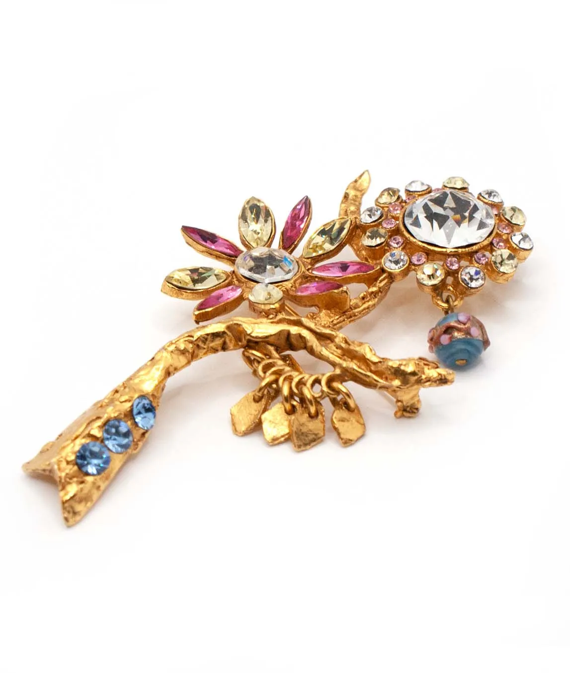 Side view of Christian Lacroix brooch with two flowers pink green clear and blue rhinestones