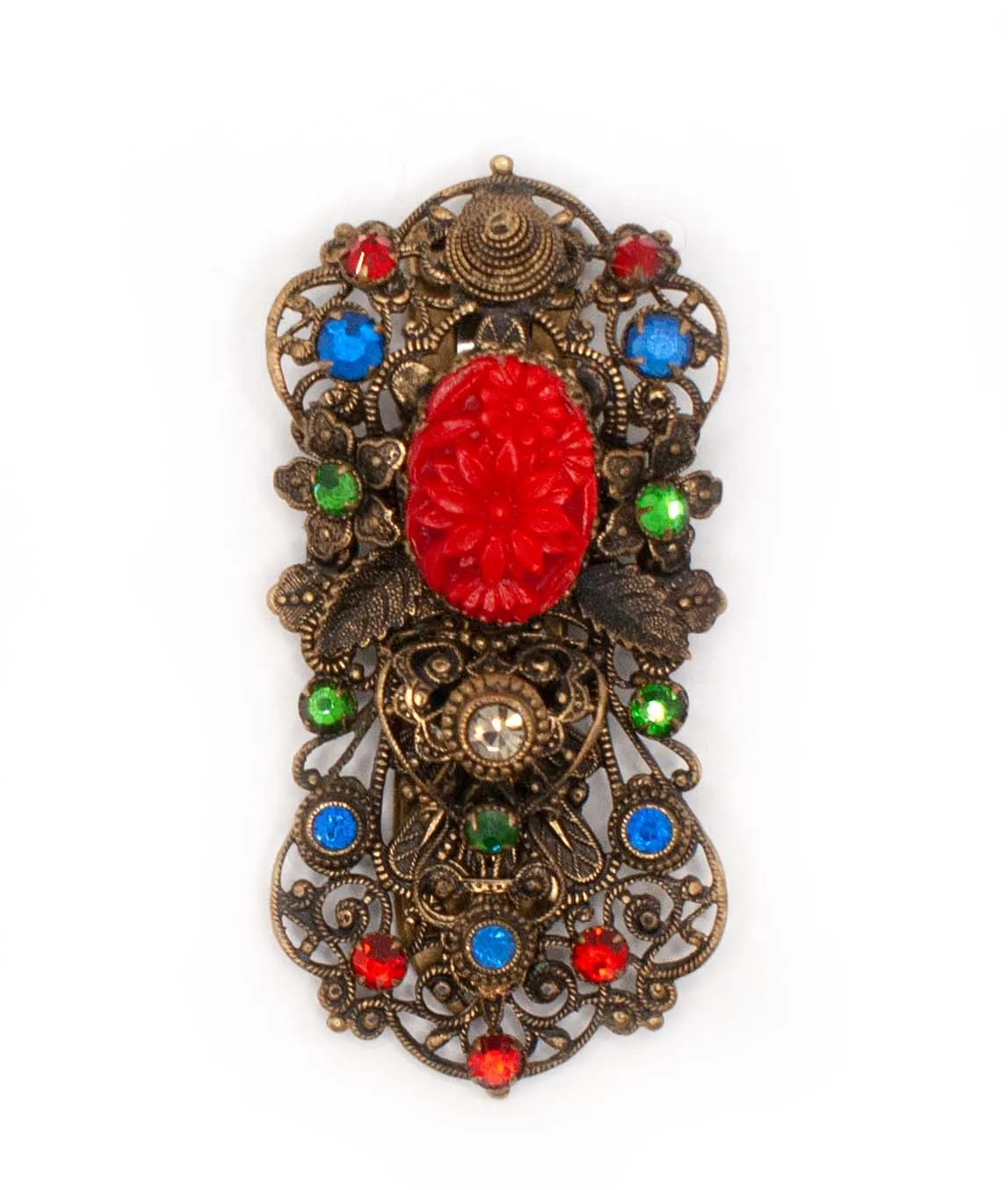 1930s Czech pierced metal dress clip decorated with red green and blue crystals and red pressed glass