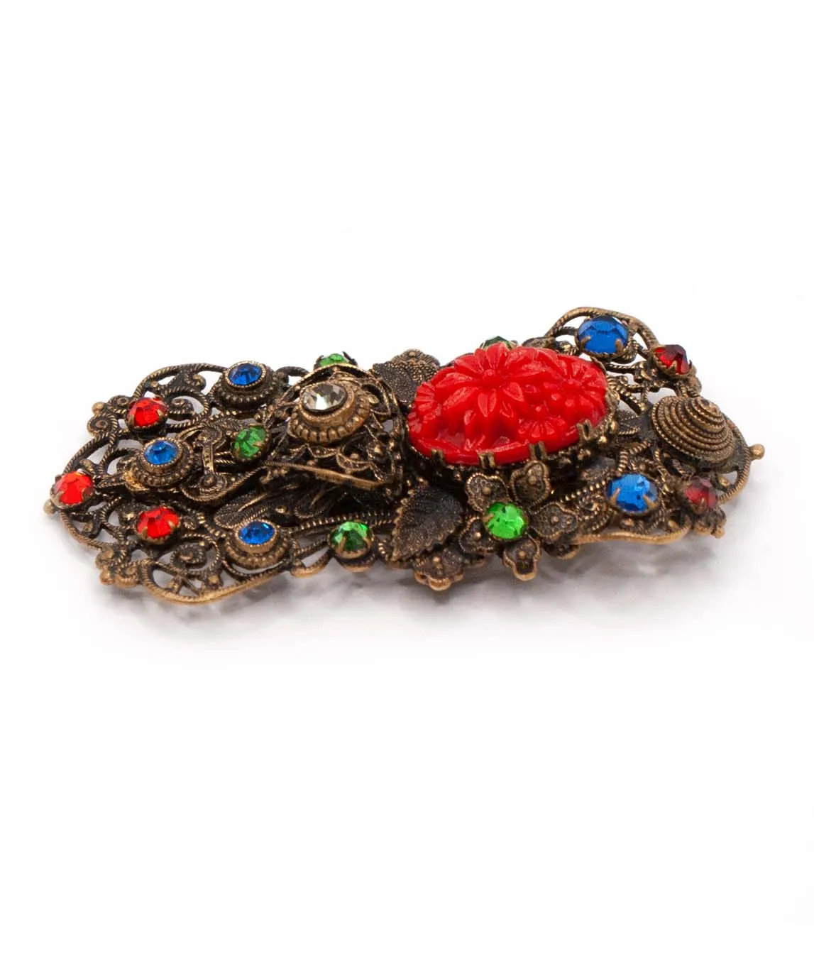 Art Deco Czech pierced metal dress clip decorated with red green and blue crystals and red pressed glass from side