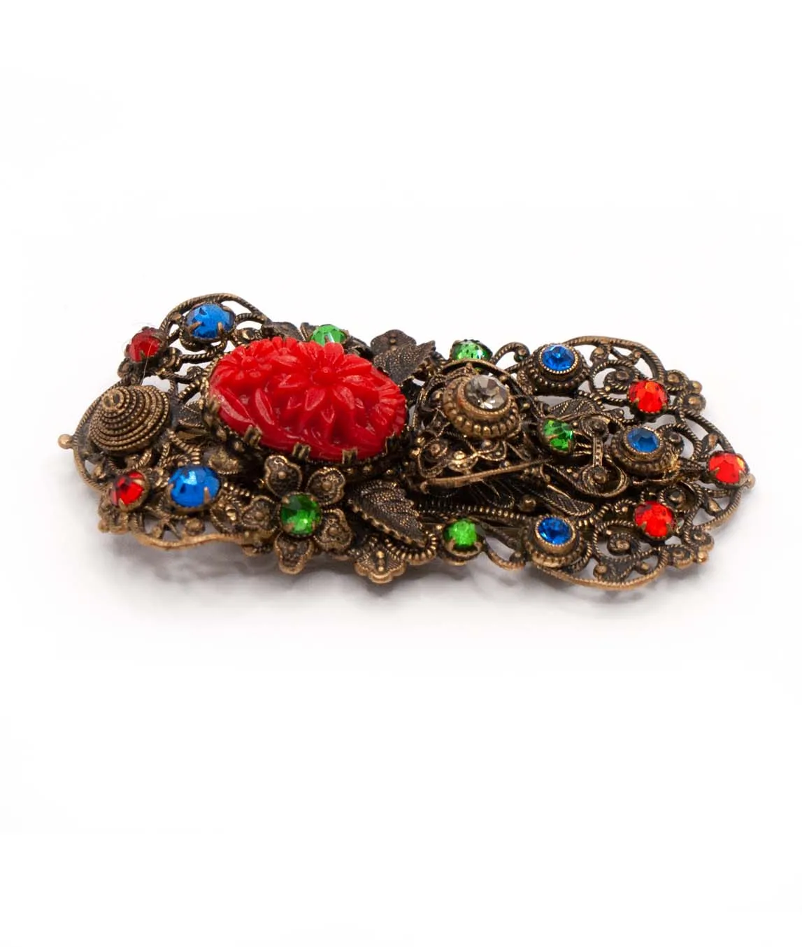 1930s Czech pierced metal dress clip decorated with red green and blue crystals and red pressed glass from side