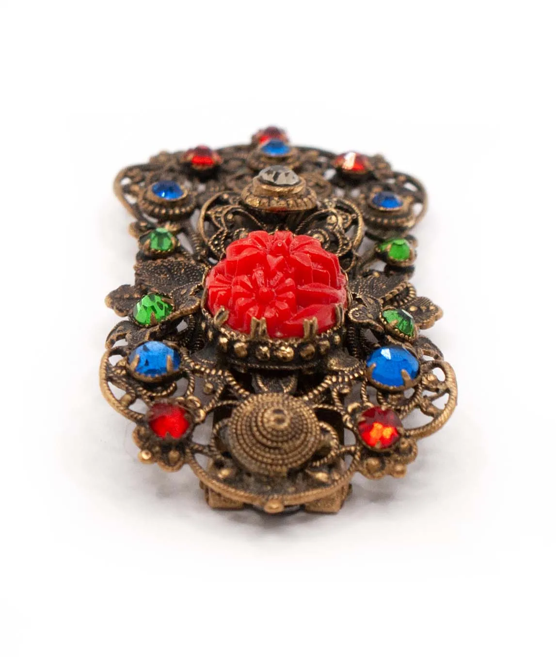 1930s Czech pierced metal dress clip decorated with red green and blue crystals and floral red pressed glass