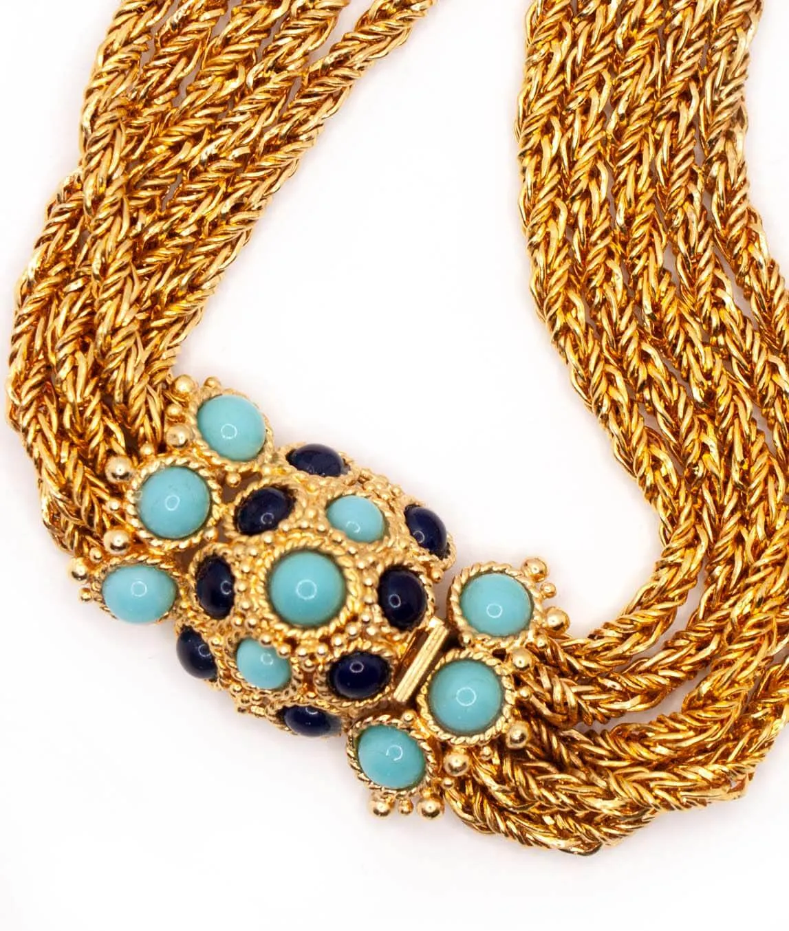 Close up of turquoise and blue glass clasp from vintage Christian Dior necklace