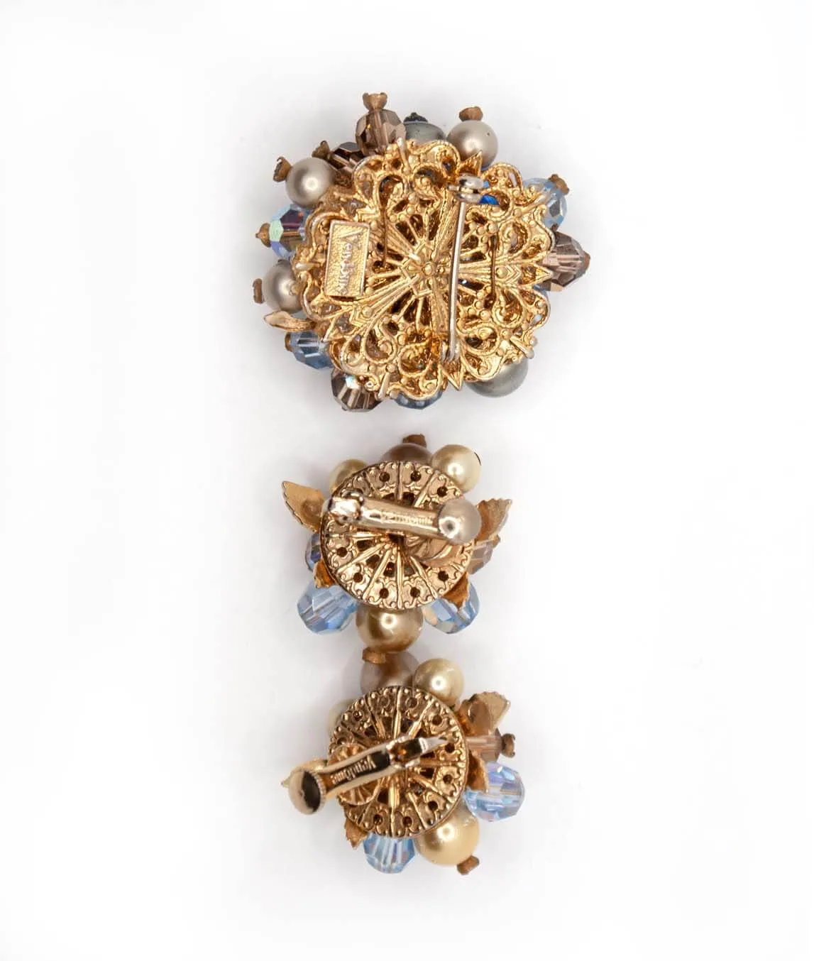 Pierced metal backing of vintage Vendôme brooch and earrings