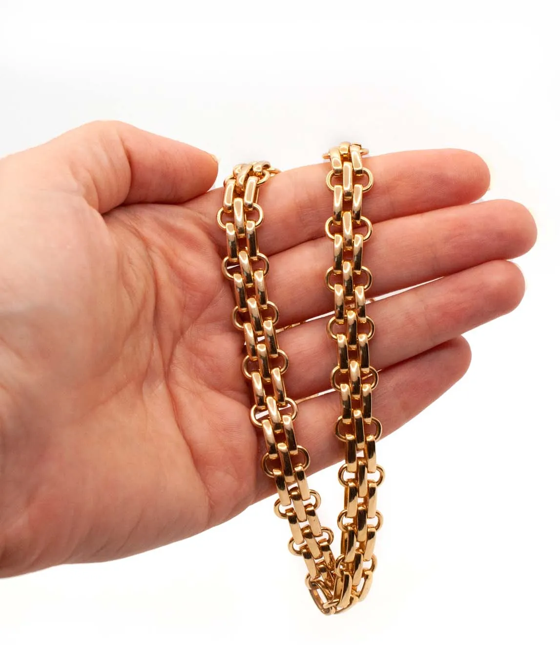 Christian Dior chunky fancy link gold plated chain necklace held in a hand
