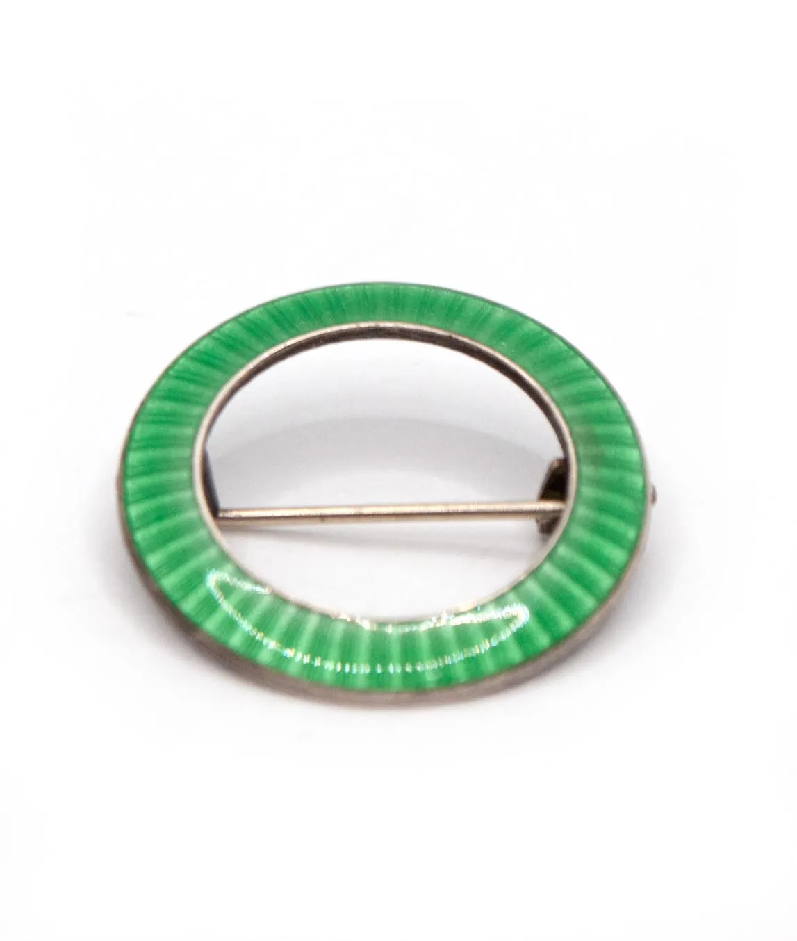 JA&S green enamelled ring shaped brooch pin set in silver on a white background