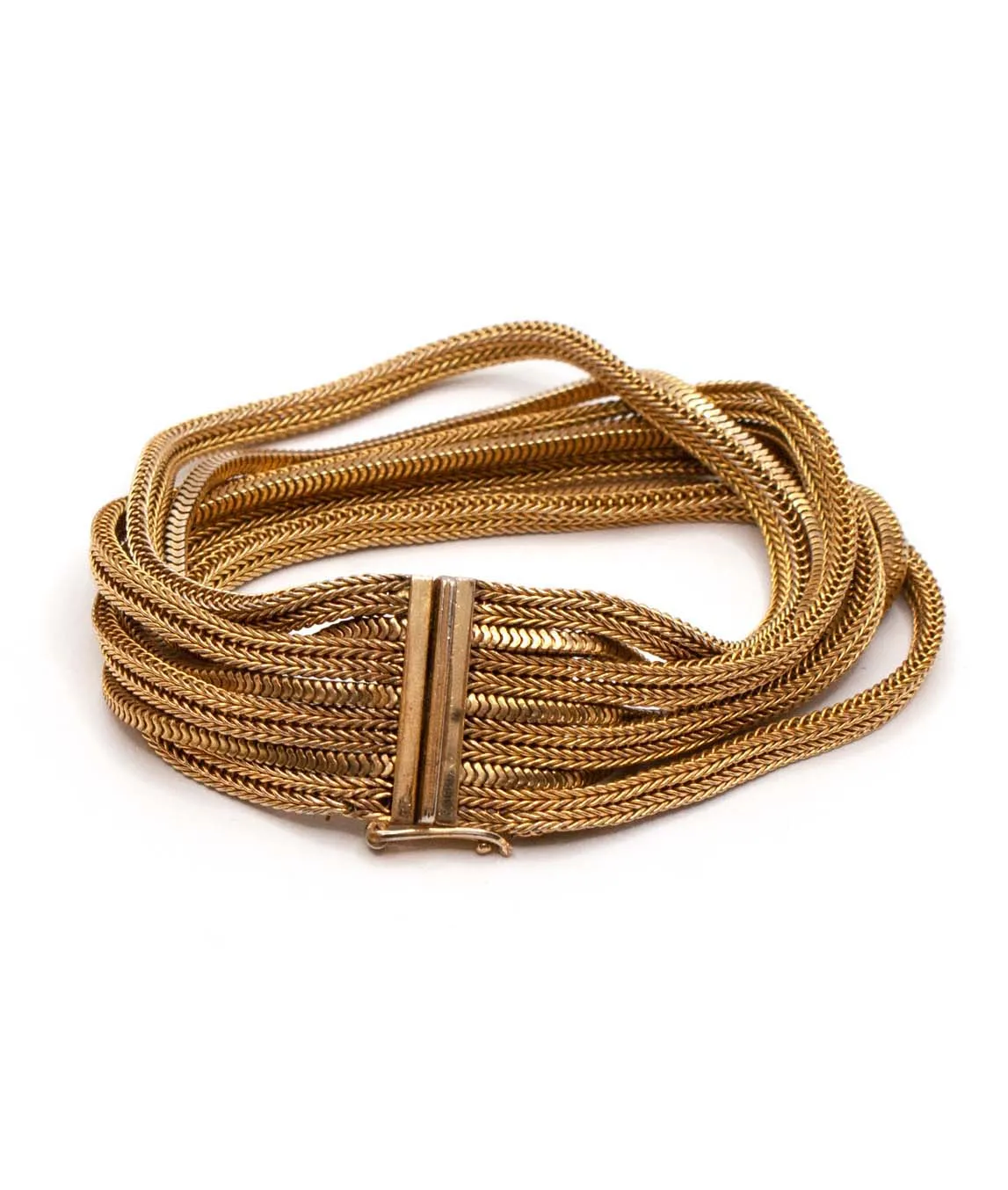 Grosse multi-chain woven gold plated bracelet fastened on a white background