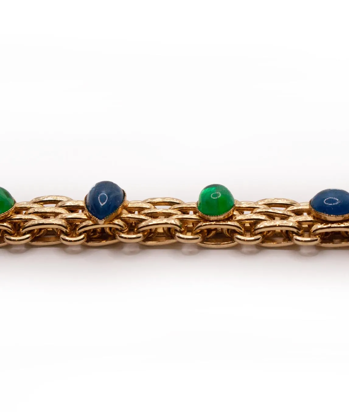 Profile view of green and blue poured glass gems on gold link bracelet by Christian Dior