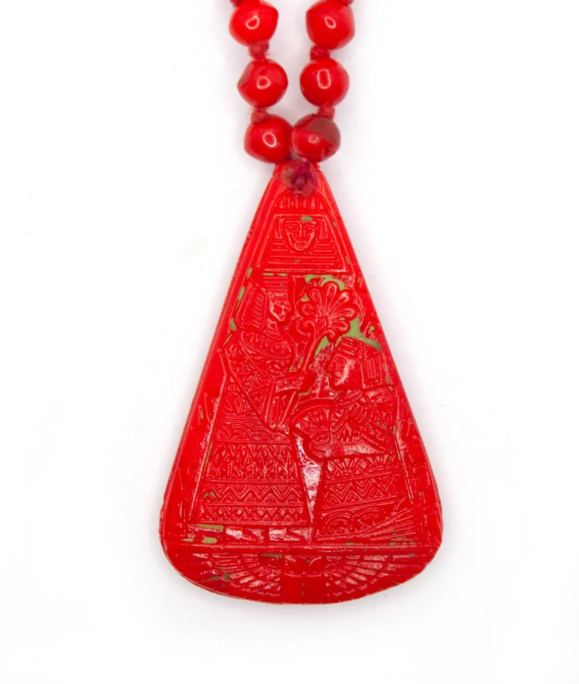 Large red pendant in pear-shape with remnants of green paint on Neiger brothers necklace