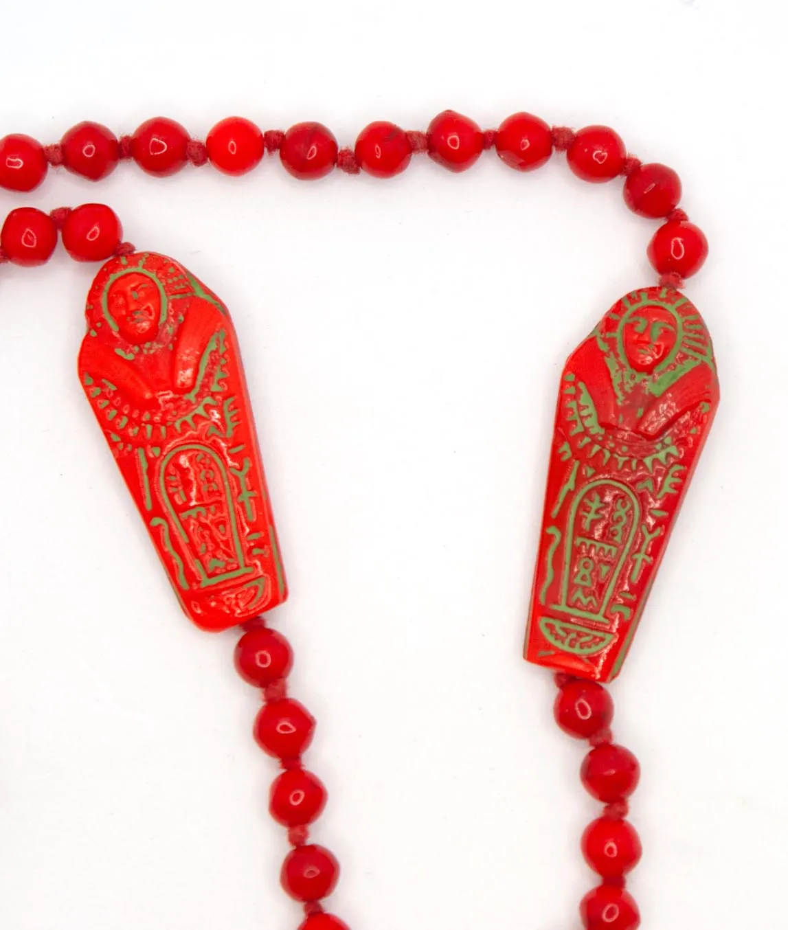 Two sarcophagus red beads with green paint on Neiger brothers beaded necklace