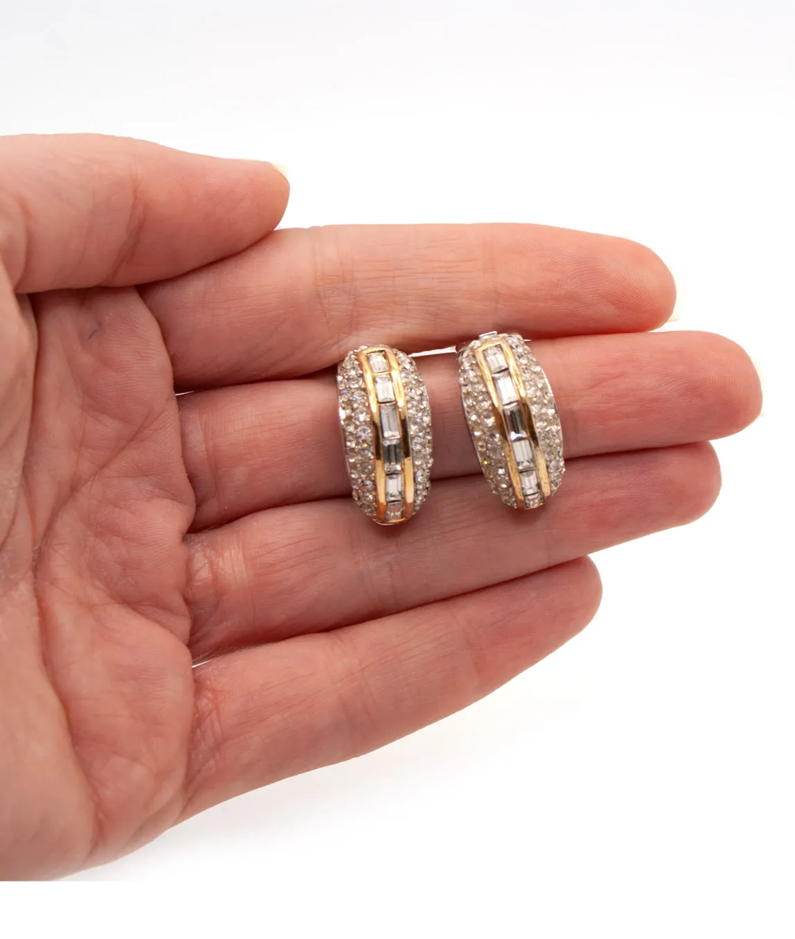 Vintage 1980s Christian Dior demi hoop earrings with rhinestones held in hand