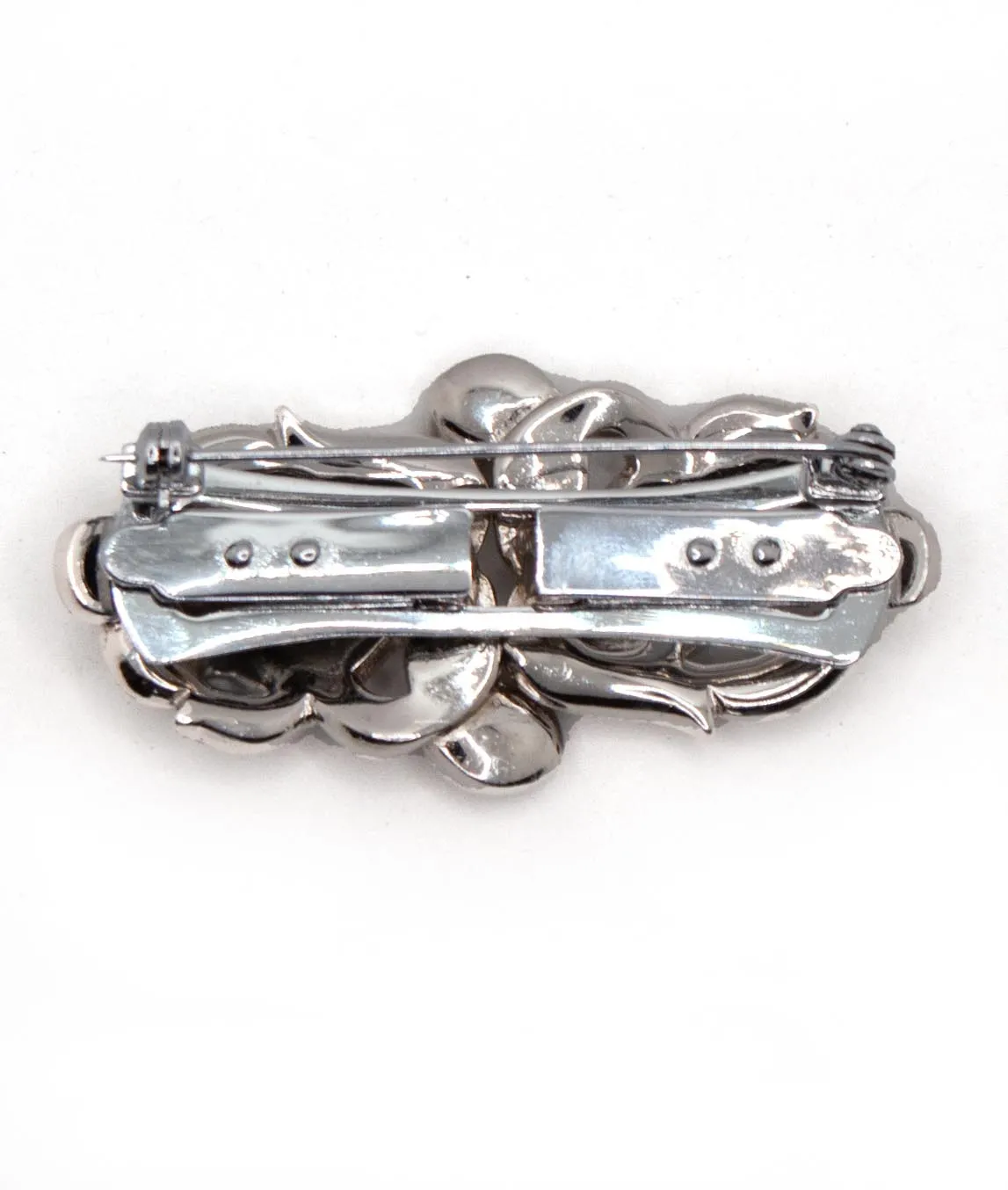Back of a double dress clip brooch which is rhodium plated