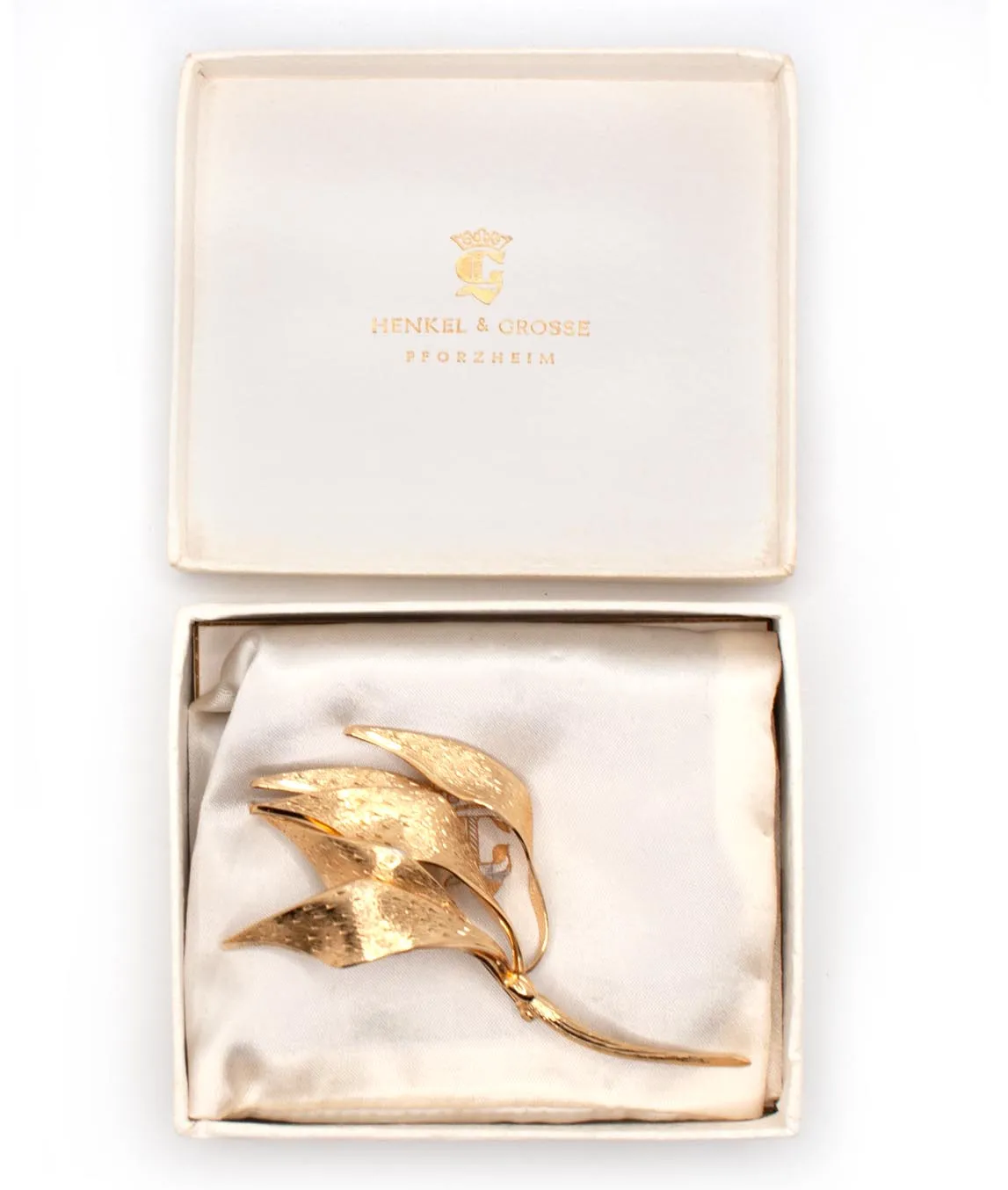 Gold-plated multi-leaf brooch by Henkel and Grosse with textured metal leaves in box with satin liner
