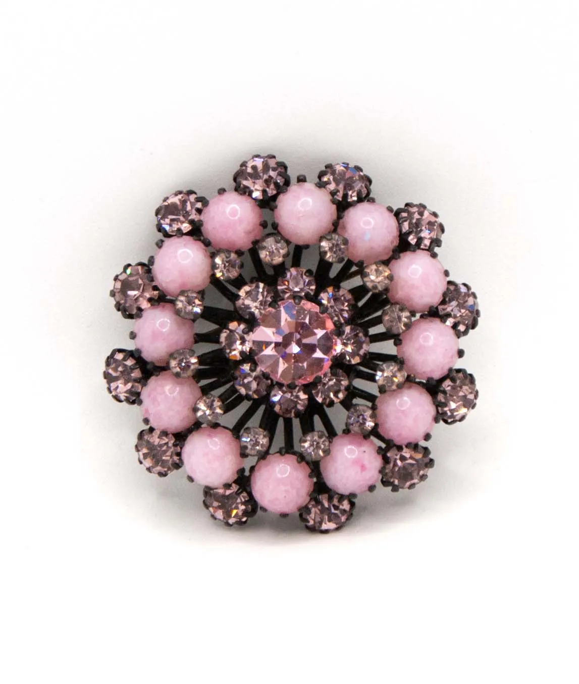 Pastel pink cluster starburst brooch with pink rhinestones set on black metal