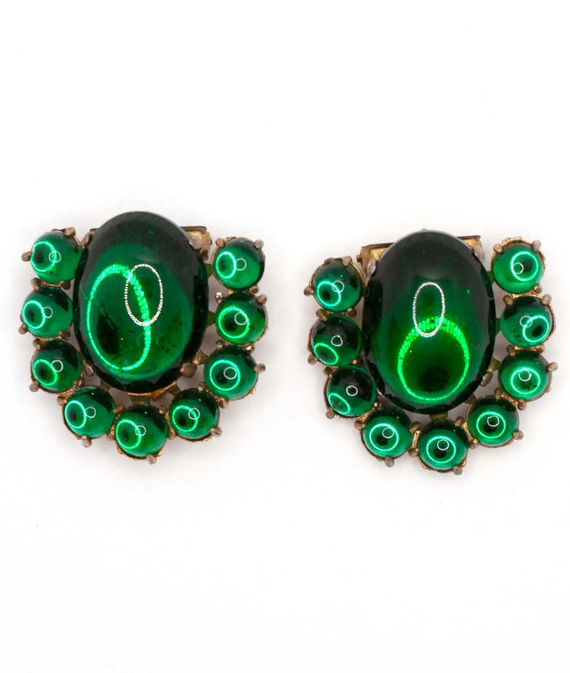 Pair of green glass cabochon dress clips with round glass stones as perimeter - top view