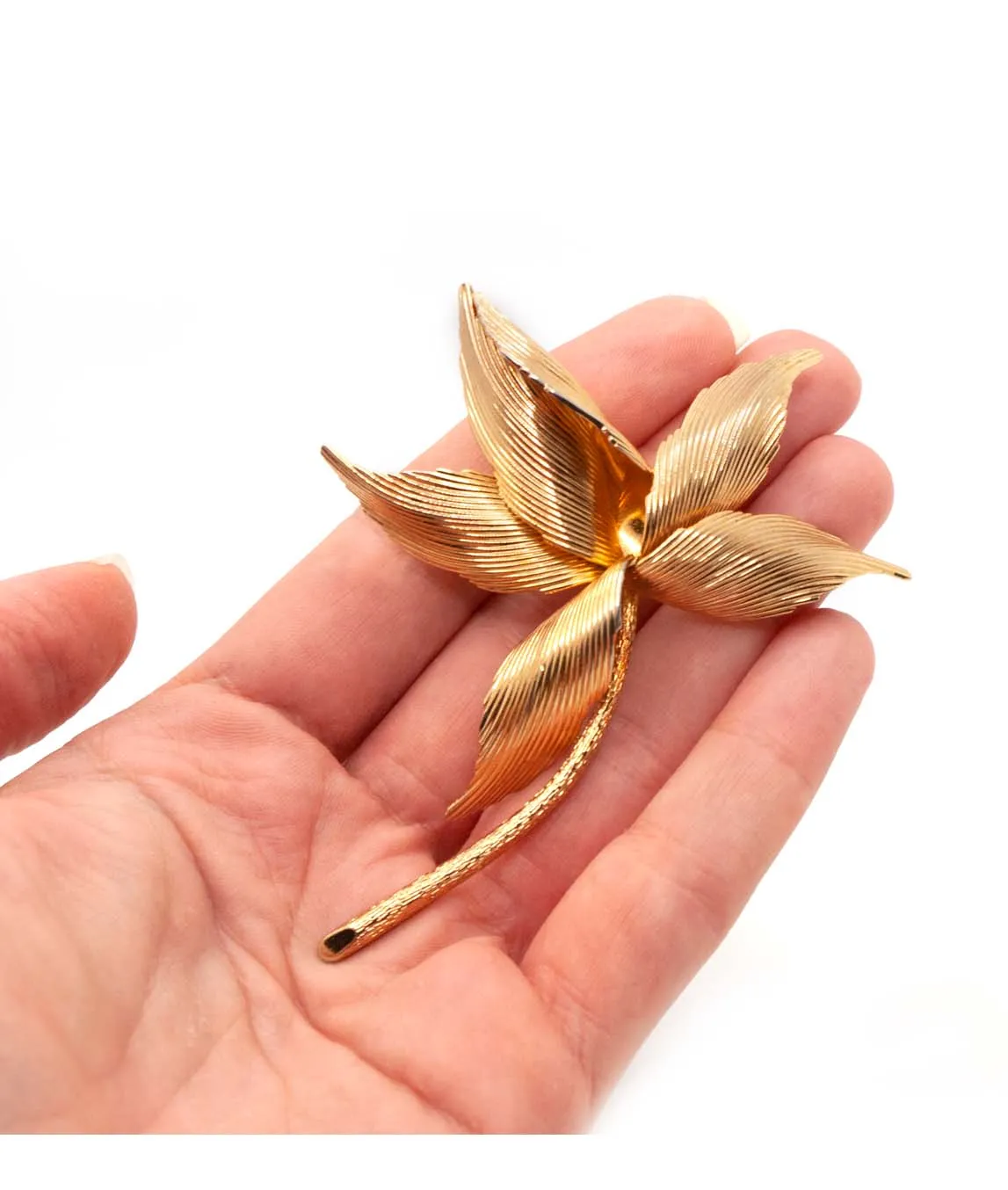 Gold plated leaf brooch from 1960 by Grossé held in a hand