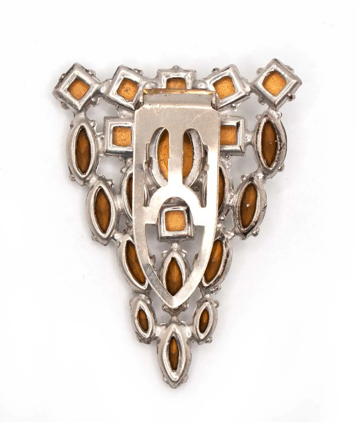 Back of triangular dress clip showing open settings for foil-backed crystals